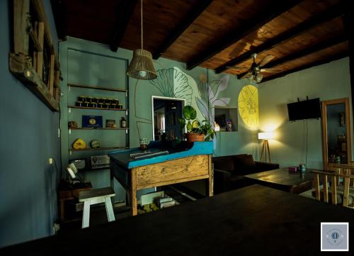 a kitchen with a sink and a table in a room at VagaMundo Hostel Carhue in Carhué