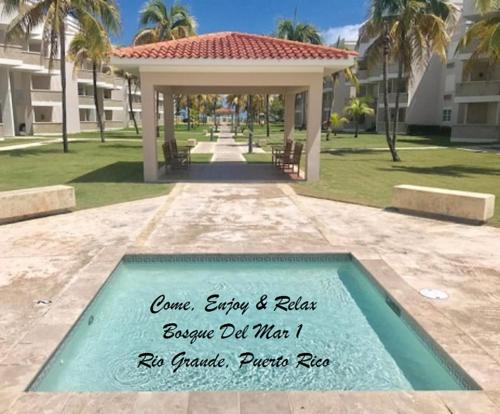 a sign in the middle of a pool in a park at Come, Enjoy & Relax Bosque del Mar 1 Rio Grande, PR in Rio Grande