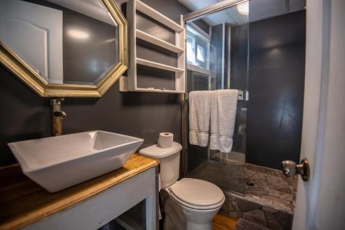 a small bathroom with a sink and a toilet at Moon Apartments in Utila