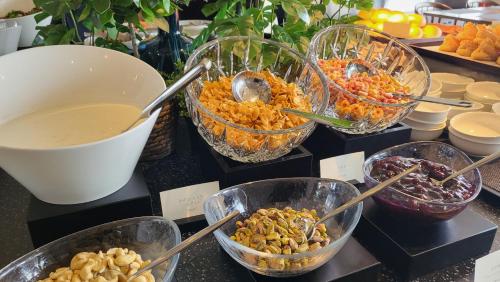 a buffet with bowls of food on a table at Solaria Nishitetsu Hotel Seoul Myeongdong in Seoul