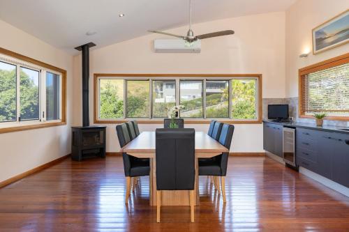 a kitchen and dining room with a table and chairs at Breakaway at Blueys in Blueys Beach