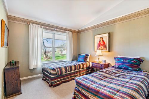 a bedroom with two beds and a window at The Wild Rose in Sagle