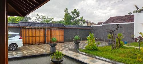 a house with a car parked in a driveway at Villa Azalea in Cireungit