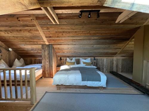 a bedroom with a bed in a wooden ceiling at Kellerstöckl Hütter in Güssing