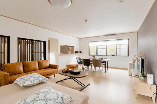 a living room with a couch and a table at Terrace Kyobate （Vacation house in Nara） in Nara
