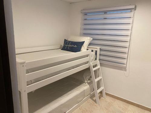 a white bunk bed in a room with a window at Fontana Sunset in Carolina