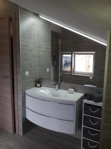 a bathroom with a white sink and a mirror at Dolce Novalja in Novalja