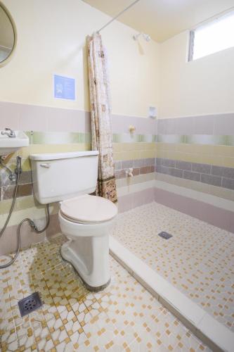 a bathroom with a toilet and a shower at Boracay Morning Beach Resort in Boracay