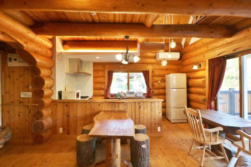 a kitchen and dining room in a log cabin at ログキャビン伊豆高原 in Futo