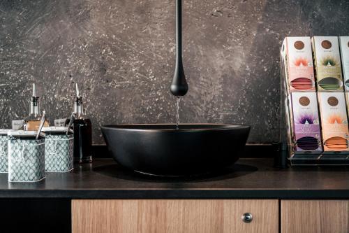 a black bowl sink sitting on top of a counter at Seehotel Panorama Relax in Resia
