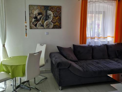 a living room with a couch and a table at Ferien- und Businesswohnung Relax im ersten Stock in Sonnen