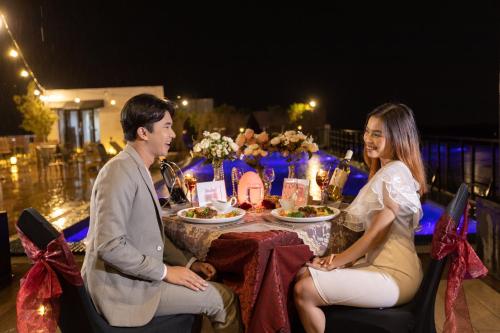 a man and woman sitting at a table with food at Satoria Hotel Yogyakarta - CHSE Certified in Yogyakarta