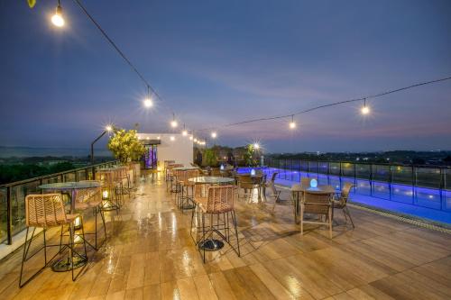 a patio with tables and chairs on a balcony at night at Satoria Hotel Yogyakarta - CHSE Certified in Yogyakarta
