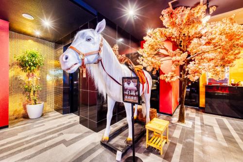 a statue of a white horse on display in a store at Hotel Lotus Gorgeous Japan Kyoto -Adult Only in Kyoto