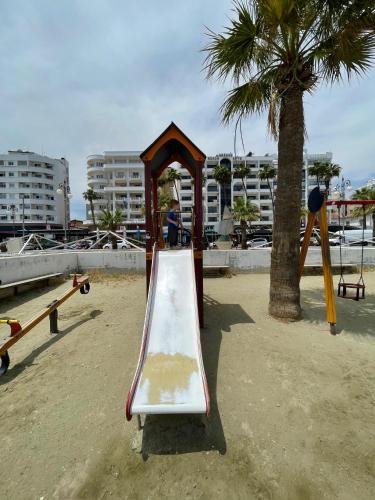 a playground with a slide on the beach at Krasas Beach in Larnaka