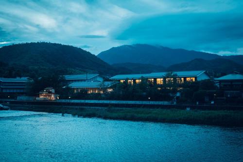 a building next to a river at night at Muni Kyoto in Kyoto