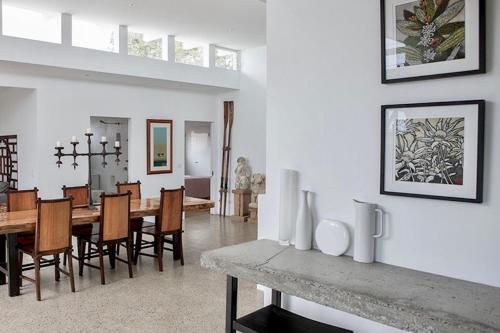 a dining room and living room with a table and chairs at THE BEACH HAVENS - Haven Oceana in Emerald Beach