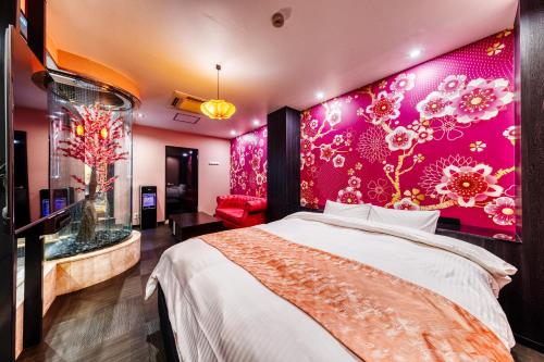 a bedroom with a large bed with a pink wall at Hotel Lotus Gorgeous Japan Kyoto -Adult Only in Kyoto