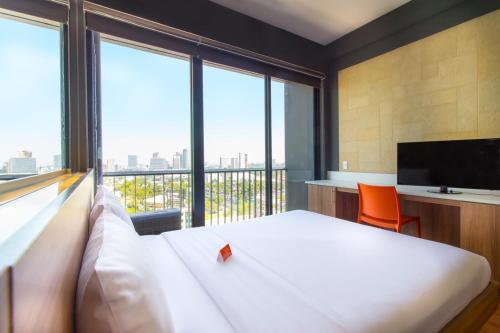 
a hotel room with a bed and a window at Azumi Boutique Hotel, Multiple Use Hotel Staycation Approved in Manila
