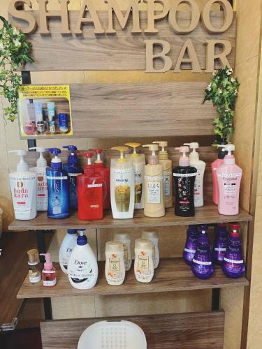 a shelf with many different bottles of hair products at premium resort nagoya in Nagoya