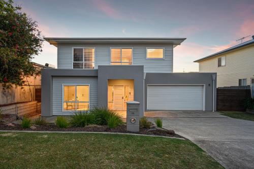 a house with a garage in front of it at Wauwa-ana - Moana - C21 SouthCoast Holidays in Moana