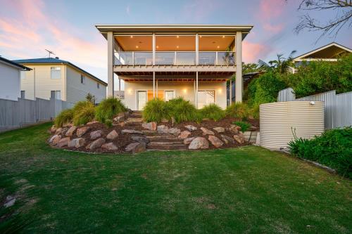 a house with a large window and a yard at Wauwa-ana - Moana - C21 SouthCoast Holidays in Moana