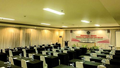 a conference room with tables and chairs in it at Grand Madani Hotel in Mataram