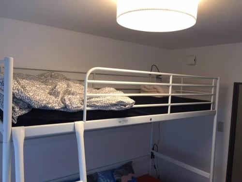 two bunk beds in a room with a light at it senriyama 101 in Senriyama