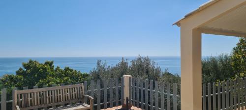 a view of the ocean from the porch of a house at Belvedere de Canaloro in Sari Solenzara