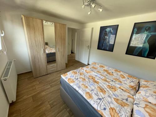 a bedroom with a bed and a mirror at Gästehaus Trulla in Bremm
