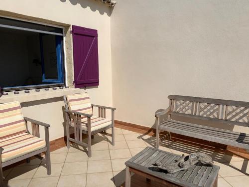 a room with two chairs and a bench and a window at Belvedere de Canaloro in Sari Solenzara