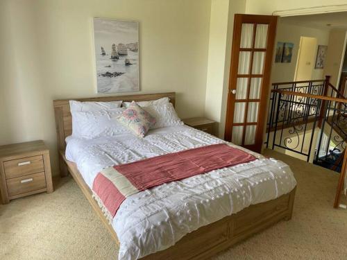 a bedroom with a bed with a wooden frame at Beautiful 5 bedroom house in Jervis Bay in Sanctuary Point