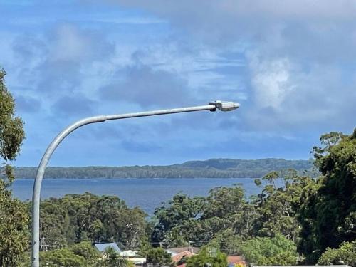 a street light with a view of a lake at Beautiful 5 bedroom house in Jervis Bay in Sanctuary Point