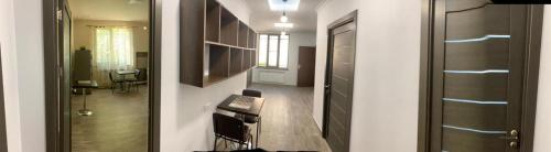 two views of a hallway with a kitchen and a living room at Sweet Home in Yerevan