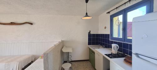 a small kitchen with a sink and a window at Belvedere de Canaloro in Sari Solenzara