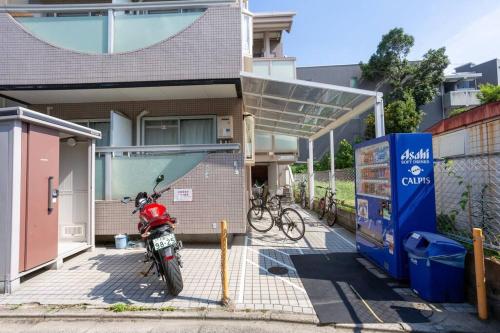 a motorcycle parked in front of a house at it senriyama 203 in Senriyama