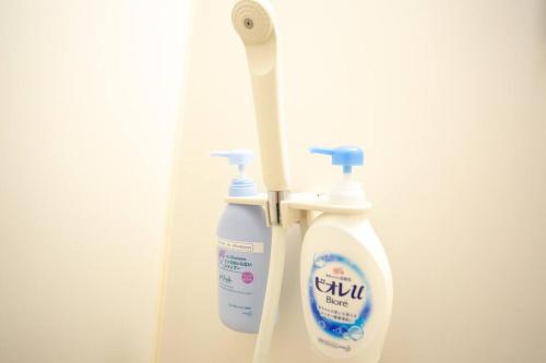 a couple of bottles of toothpaste and a toothbrush at it senriyama 203 in Senriyama