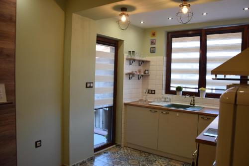 a kitchen with a sink and a window at Boutique House Belevi in Nesebar