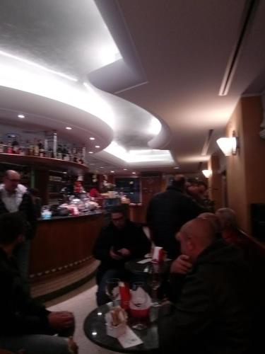 a group of people sitting at a bar at Albergo Trattoria AL TAJ in Sevegliano