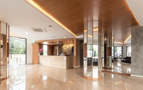 a lobby with a bar in a building at The Proud Exclusive Hotel-SHA Plus in Nakhon Pathom