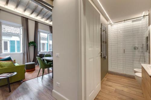 a bathroom with a shower and a toilet in a room at Turandot Apartment by Mamo Florence in Florence
