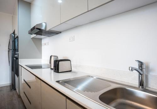 a kitchen with a sink and a counter top at Yaya Hotel & Apartments in Nairobi