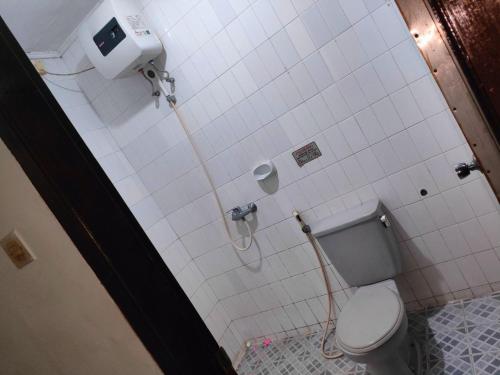 a bathroom with a toilet and a shower stall at Wisma Hari Kota in Medan