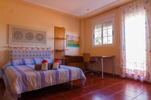 a bedroom with a bed and a desk in it at Casa Torre del Virrey in La Eliana