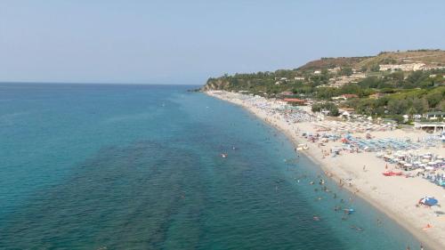 an aerial view of a beach with people in the water at Resort Sciabache in Zambrone