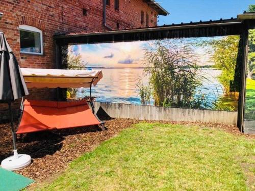 a mural of a lake on the side of a building at Ferienwohnung Seenrunde in Quadenschönfeld