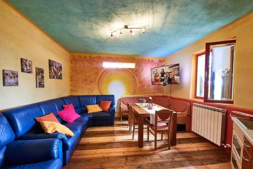 a living room with a blue couch and a table at Krasberry in Komen