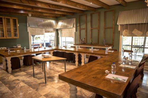 a restaurant with wooden tables in a room at Big 5 Guest House Witbank in Witbank