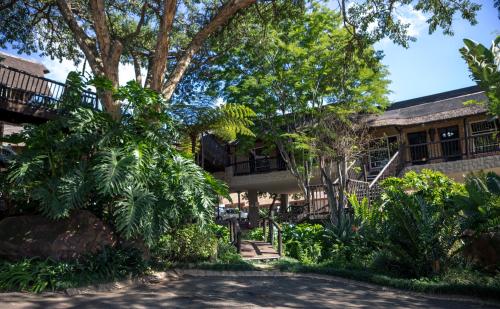 a building with trees and plants in front of it at Big 5 Guest House Witbank in Witbank