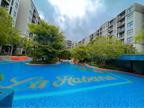 a large blue pool with the words stay haciendas on it at La Habana Huahin by Ying in Hua Hin